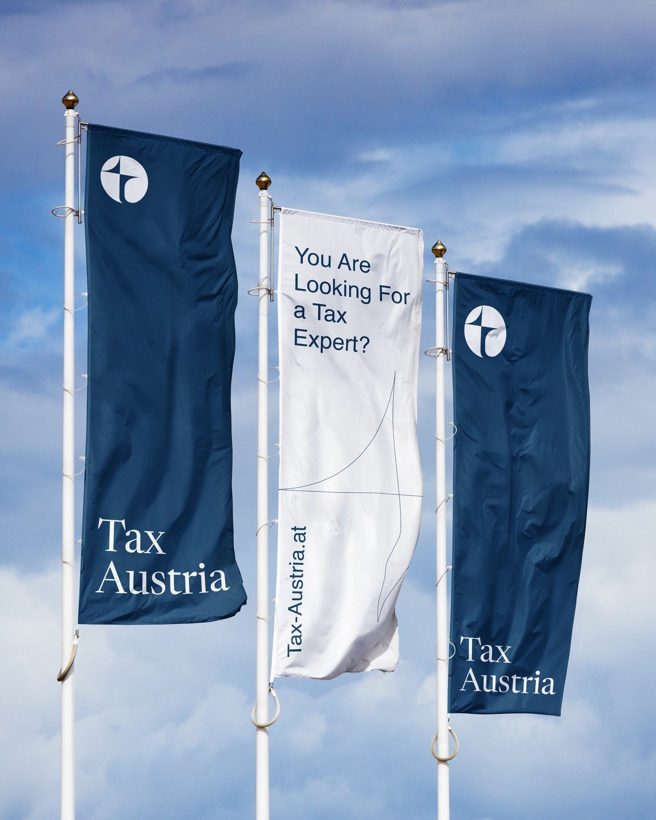 Drei Fahnen vor blauem Himmel, zwei in Navy mit Bild- und Wortmarke, eine weiße mit „You Are Looking For a Tax Expert?“